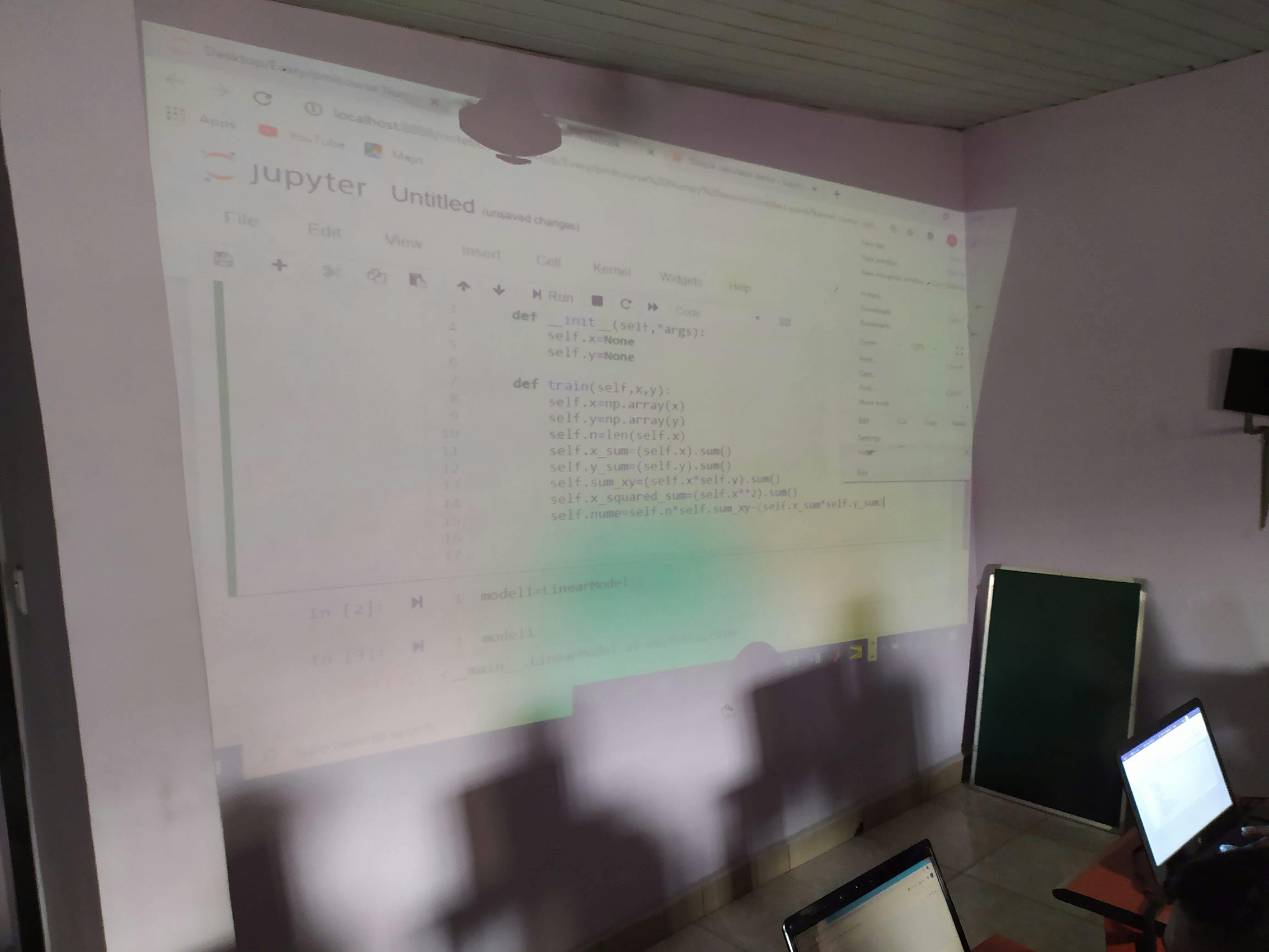 Projected content to the wall, containing a bunch of code.