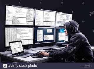 hacker-using-multiple-computers-for-stealing-data-R68NR3.jpg