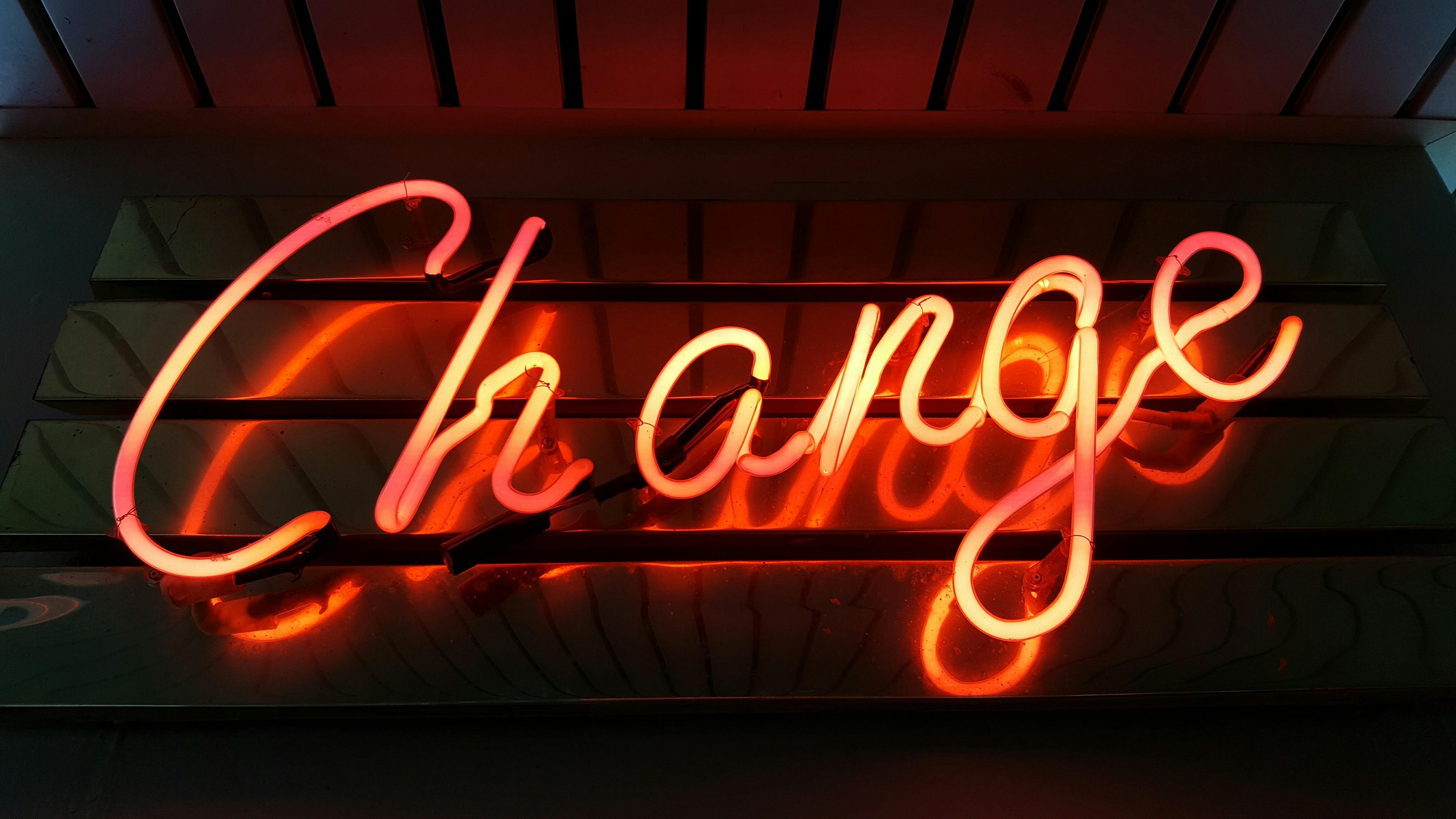 Picture of a neon light that says change