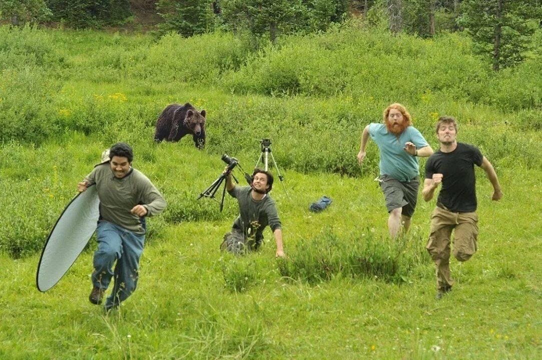 Men running from a charging bear. One has tripped. He is doomed.