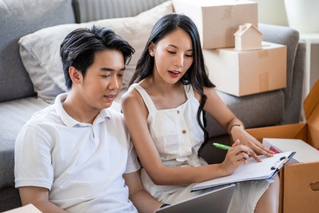 young-beautiful-asian-couple-love-moving-new-home-sitting-floor-very-happy-cheerful-new-apartment-around-cardboard-boxes-holding-cardboard-boxes-while-moving-home_33413-418.jpg