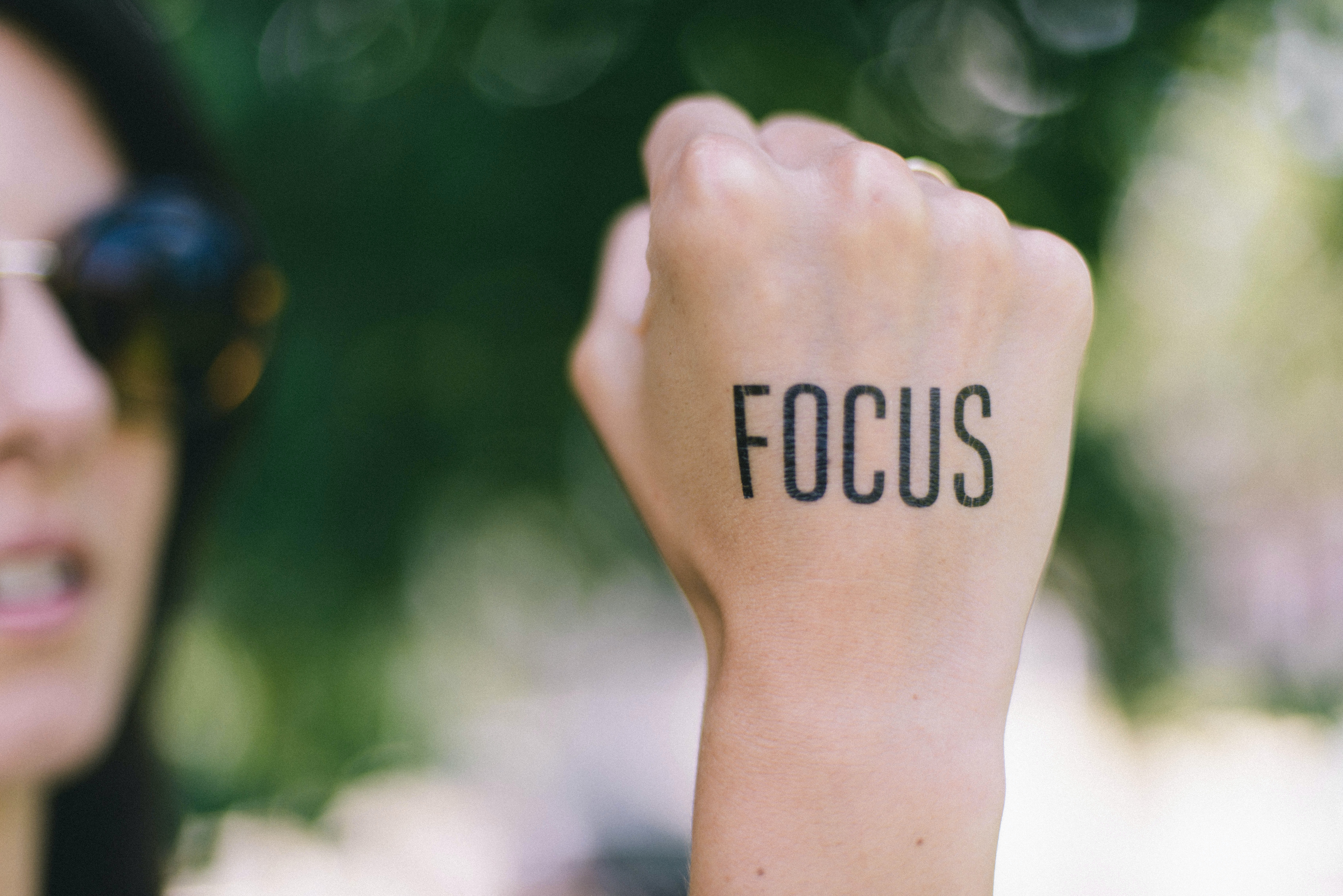 A women with focus written on her hand