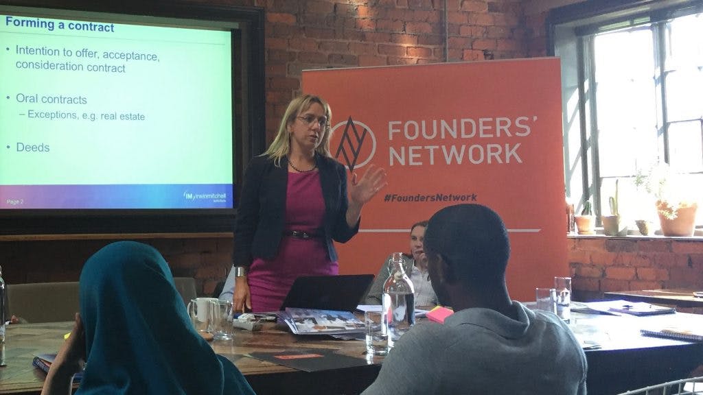 Andrea Cropley Stood in-front of the 'Founders Network' sign