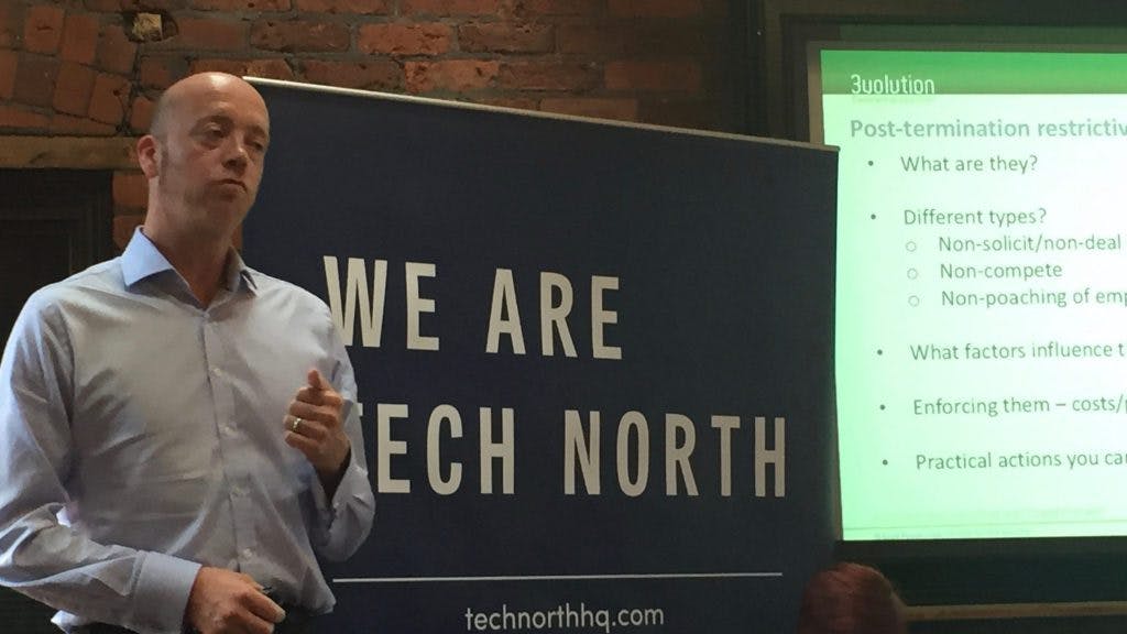 Paul Ball stood in-front of the 'We Are Tech North' sign