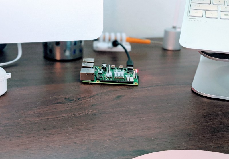 A closeup of the Pi between the Mac and the laptop