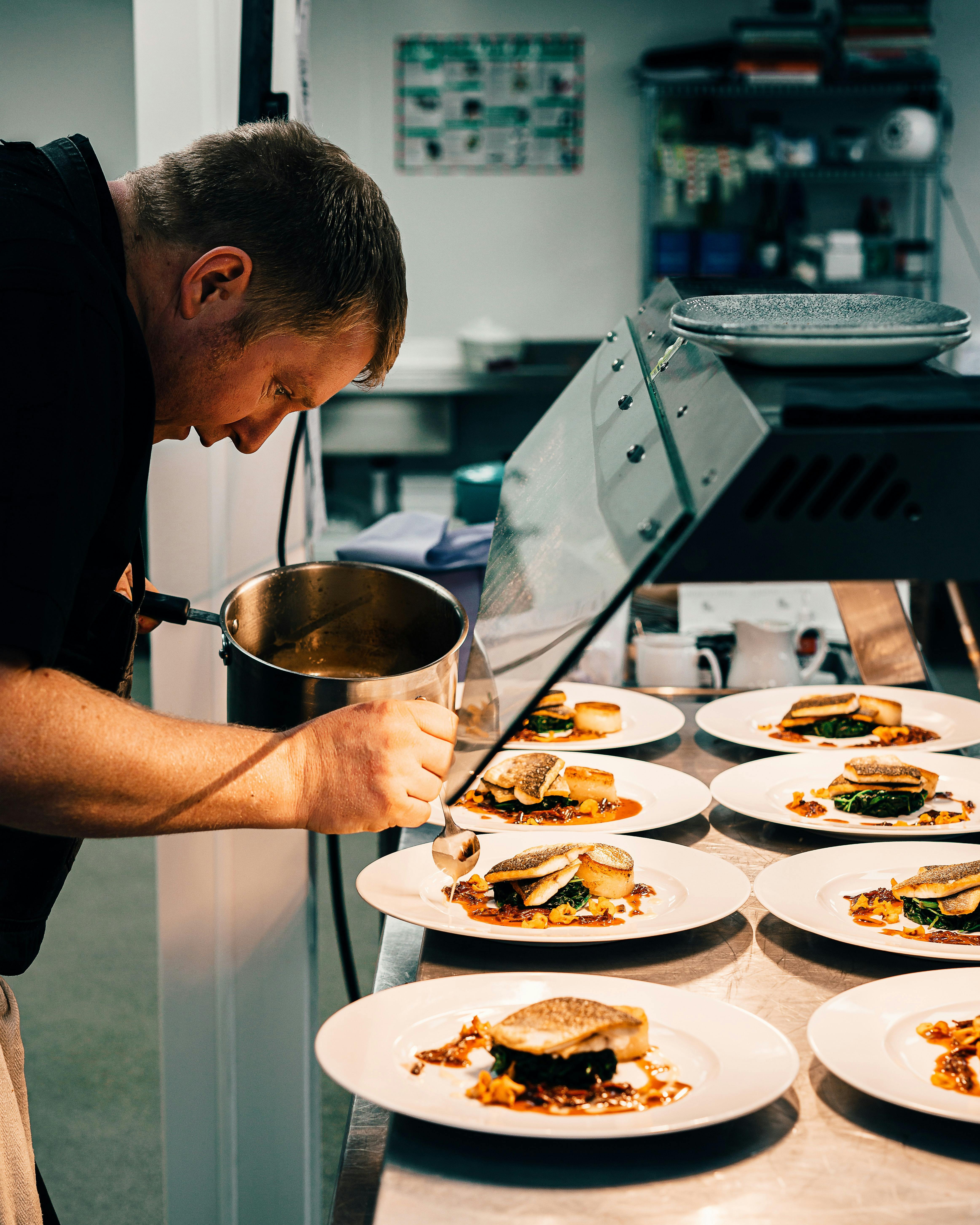 chef preparing several plates