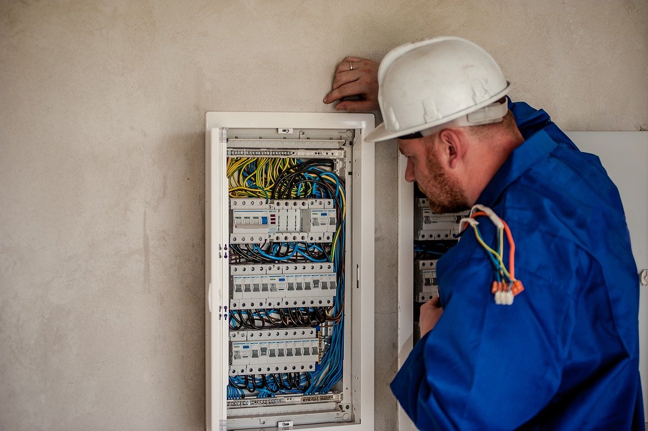 electrician looking at a switchboard