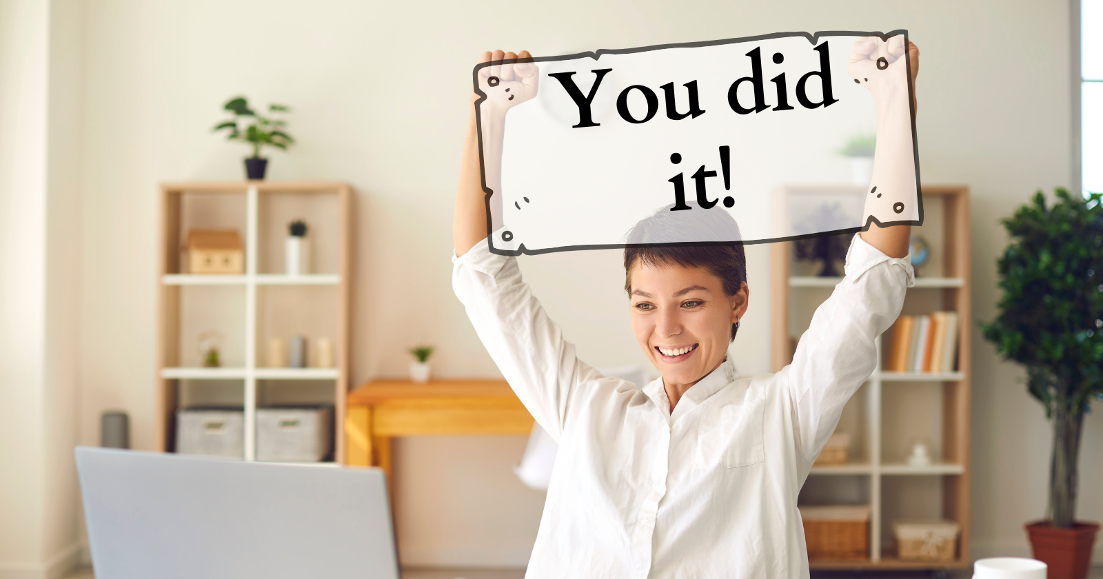 Photo of a person who looks excited, with a sign edited over the top of their hands. The sign reads 'You did it!' - It is meant to be encouraging, to tell others who just completed something to congratulate themselves!