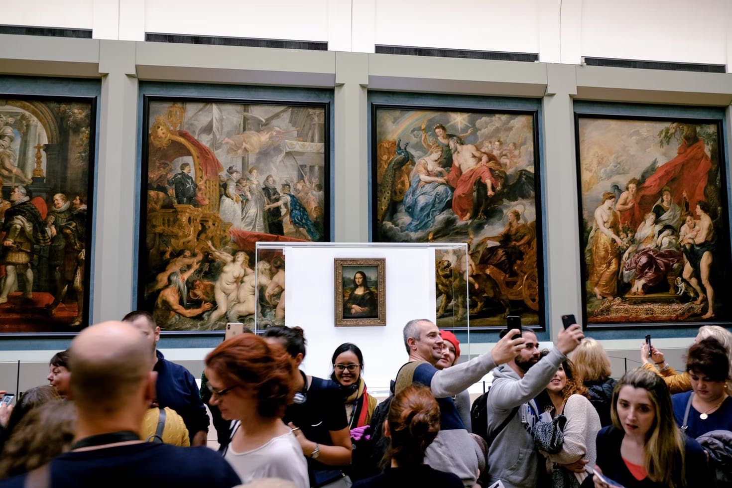 Tourists in front of Mona Lisa at the Louvre Museum