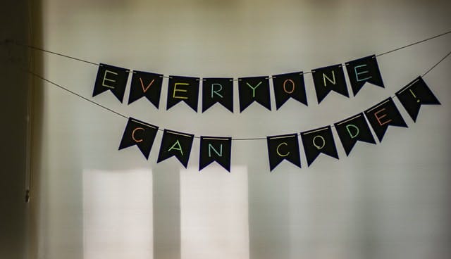 A black and white banner that says everyone can code.