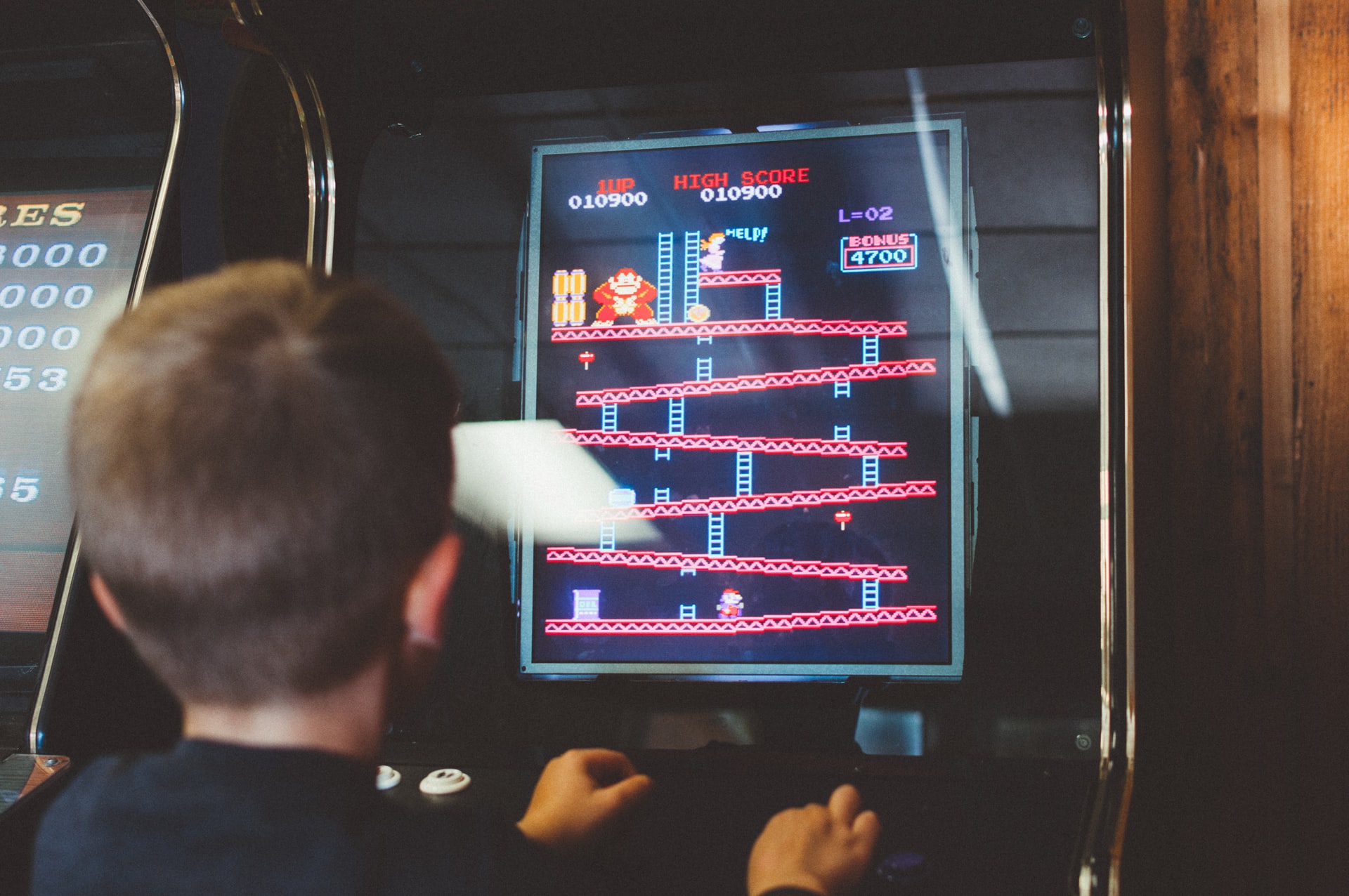 A child playing an arcade game.