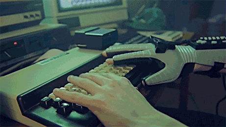 Hackerman from Kung Fry typing on a keyboard with a Nintendo Power Glove