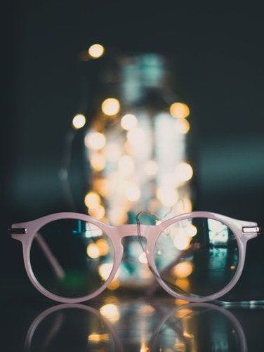 spectacles infront glass jar
