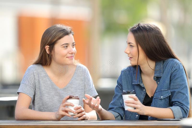 two-friends-talking-park-drinking-coffee-casual-142926028.jpg