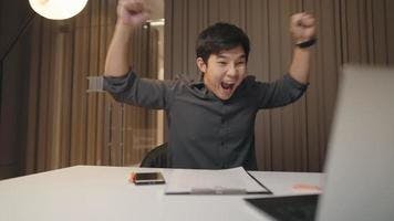 happy-asian-male-company-worker-celebrating-at-the-working-desk-after-done-closing-business-deal-with-clients-online-successful-businessman-expressing-glad-and-cheerful-emotion-job-done-complete-video.jpg