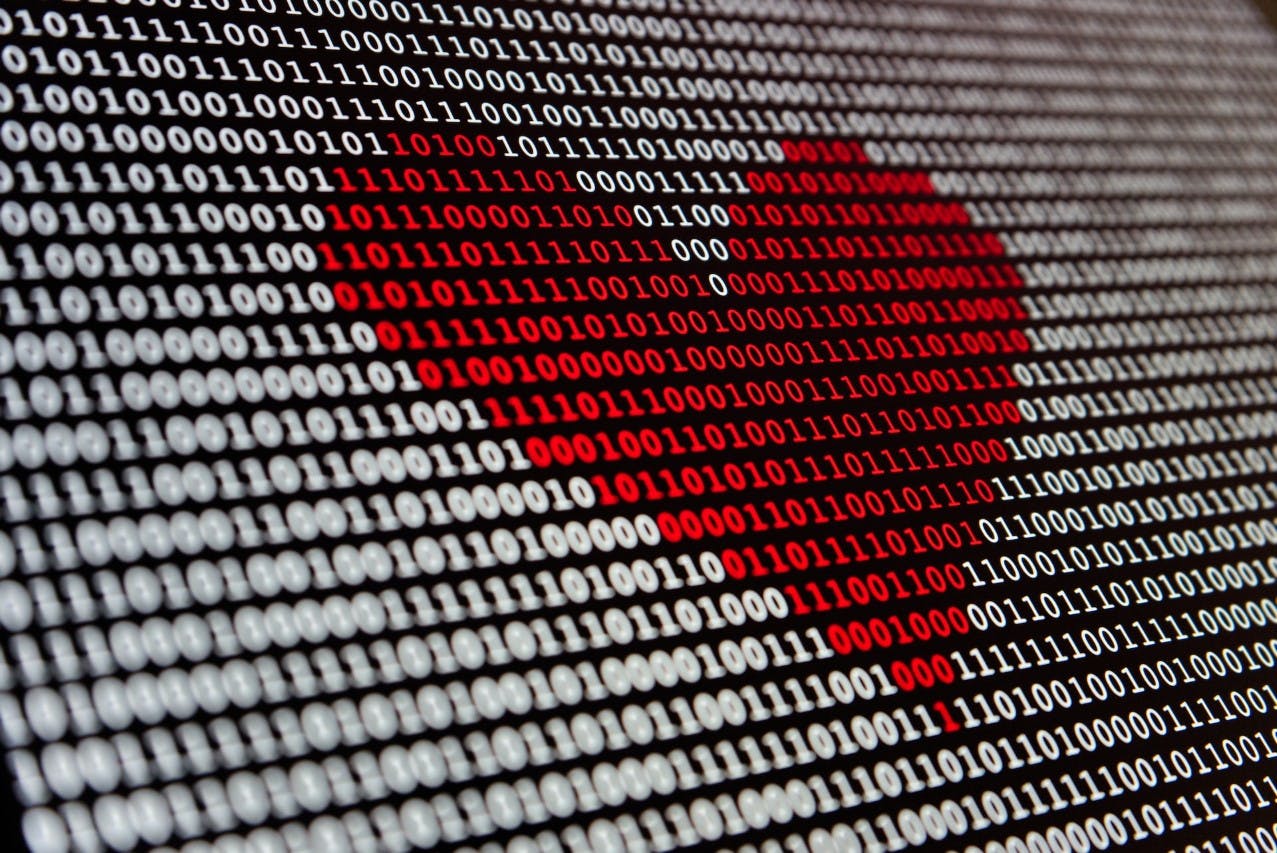 A heart is shown on a computer screen with 0 an 1.