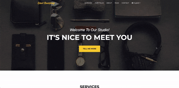 A screenshot of the original Gatsby starter template this project was built from - the heading reads "Welcome To Our Studio! It's nice to meet you" above a background image of everyday carry items such as headphones, a watch, sunglasses, and a wallet