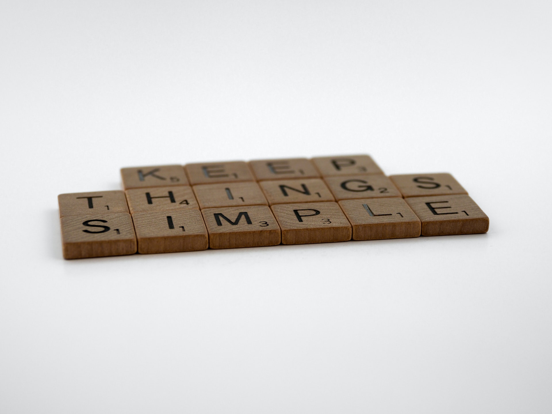 A scrabble tile that says keep things simple.
