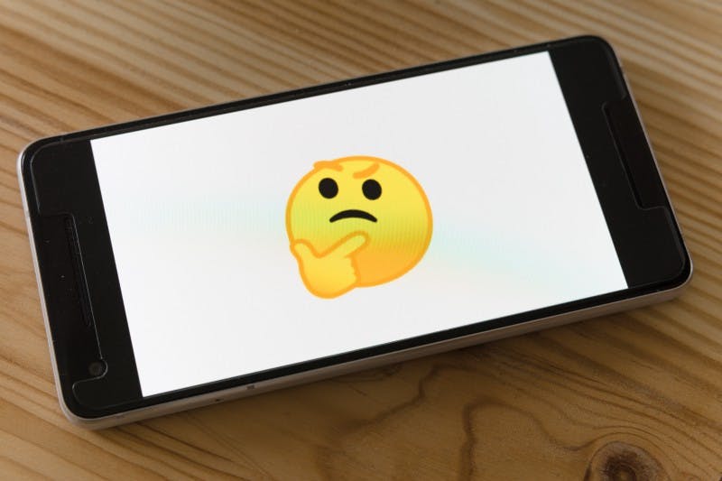 a large image of the thinking emoji displayed on a phone