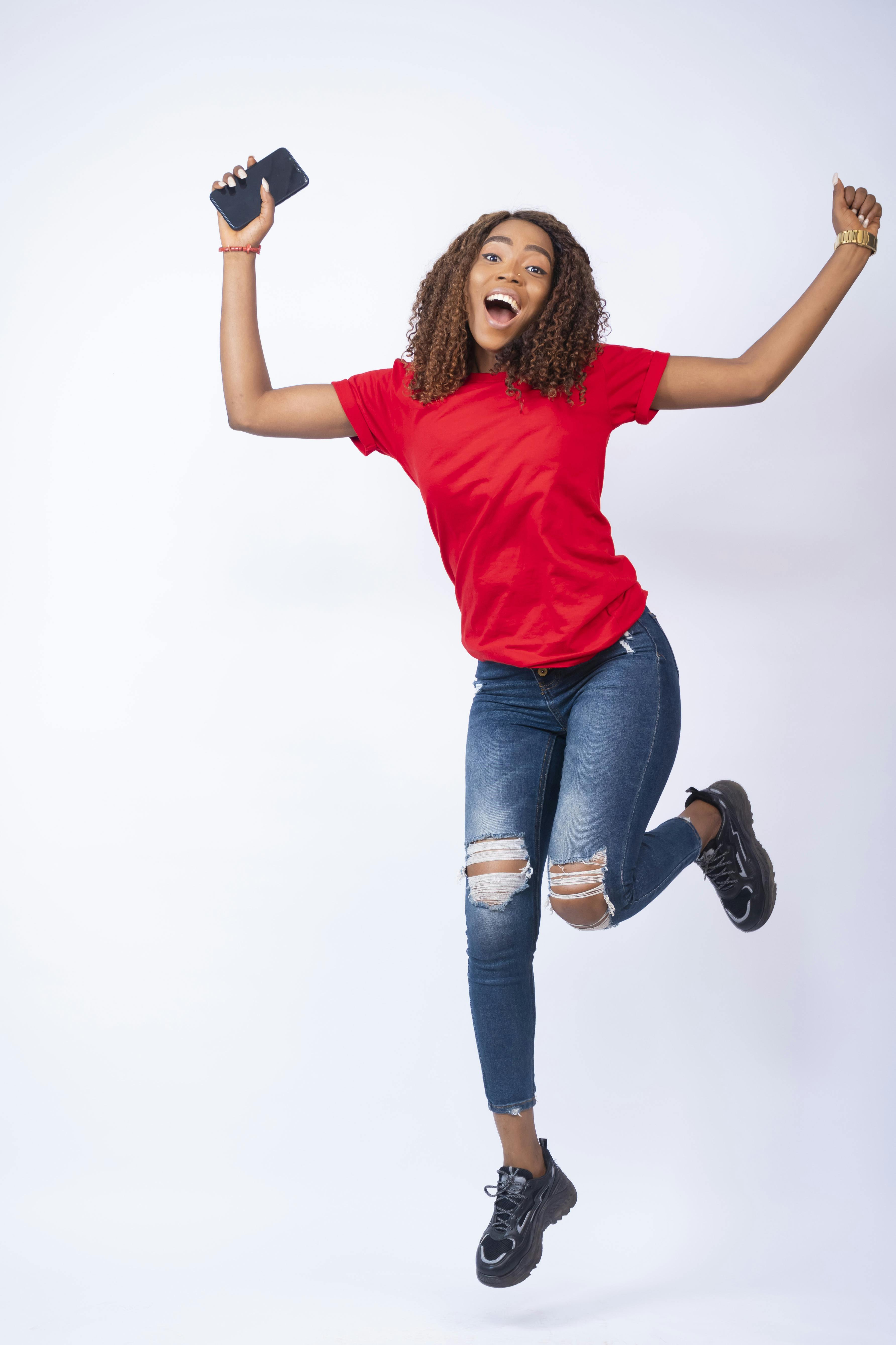 vertical-shot-happy-african-female-jumping-excitement.jpg