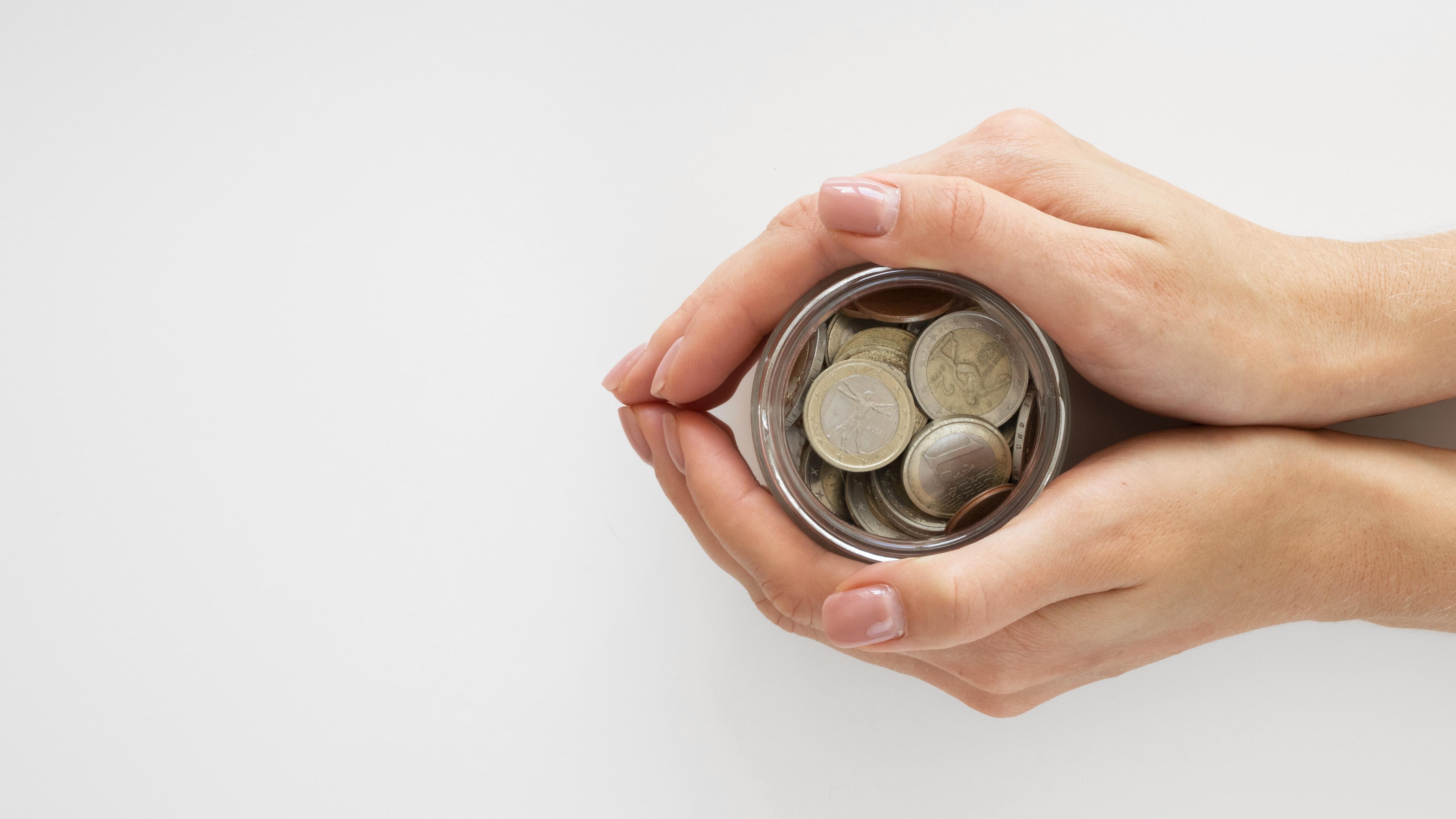 person-holding-jar-with-coins.jpg
