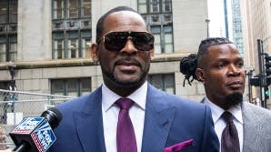 R. Kelly and his publicist Darryll Johnson, right, leave The Daley Center after an appearance in court for Kelly's child support case, Wednesday, March 13, 2019, in Chicago. (Ashlee Rezin/Chicago Sun-Times via AP)