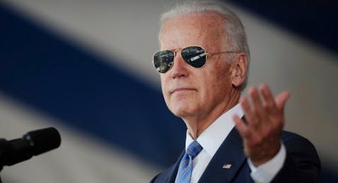 Vice President Joe Biden gestures after donning a pair of sunglasses as he delivers the Class Day Address at Yale University, Sunday, May 17, 2015, in New Haven, Conn. Biden urged graduating students to question the judgment of others, but not their motives to build consensus. (AP Photo/Jessica Hill)