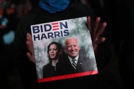 WILMINGTON, DELAWARE - NOVEMBER 07: A supporter of President-elect Joe Biden shows a calendar with Biden and Vice President-elect Kamala Harris on cover outside the Chase Center where Biden addressed the nation November 07, 2020 in Wilmington, Delaware. After four days of counting the high volume of mail-in ballots in key battleground states due to the coronavirus pandemic, the race was called for Biden after a contentious election battle against incumbent Republican President Donald Trump. (Photo by Joe Raedle/Getty Images)