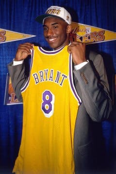 INGLEWOOD, CA - JULY 11: Kobe Bryant holds a #8 Los Angeles Lakers jersey after being the 13th overall pick in the 1996 NBA Draft by the Charlotte Hornets who then traded his draft rights to the Los Angeles Lakers on July 11, 1996 in Inglewood, California. NOTE TO USER: User expressly acknowledges and agrees that, by downloading and/or using this Photograph, user is consenting to the terms and conditions of the Getty Images License Agreement. Mandatory Copyright Notice: Copyright 1996 NBAE (Photo by Juan Ocampo/NBAE via Getty Images)