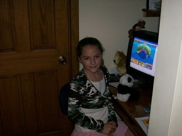 Me, six or seven years old, Playing Webkinz  on a computer at my grandma's house (you literally could not get me away from the computer if you tried)