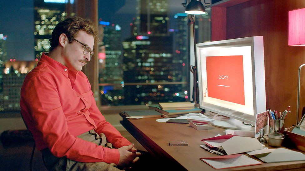 Theodore Twombly (played by Joaquin Phoenix) staring at computer screen awaiting the installation of Samantha OS, an artificially intelligent virtual assistant, in movie 2013-released movie "Her"