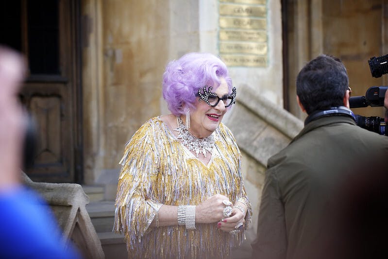 Dame Edna Everage in a gold dress