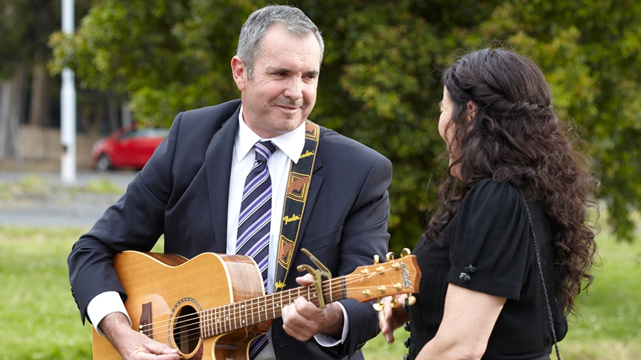 Dr. Karl Kennedy playing guitar