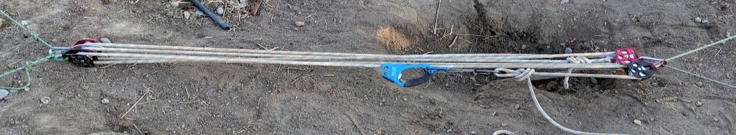A block and tackle with two built-in pulleys, plus two extra independent pulleys, and an ascender holding everything in place.
