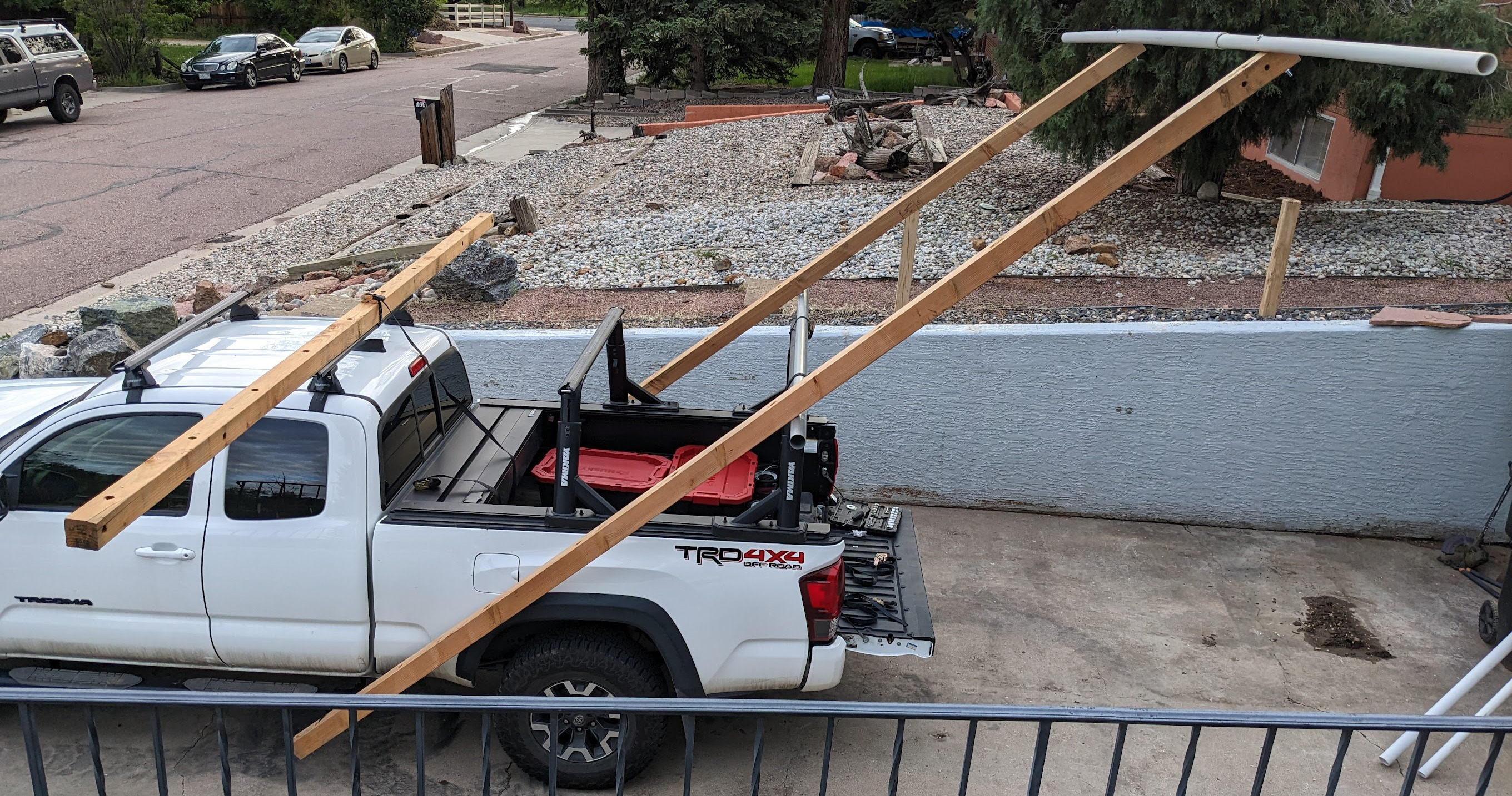 My truck, with lumber attached to it, holding a pipe in the air above my driveway.  It is held upwards and behind my truck like a giant spoiler