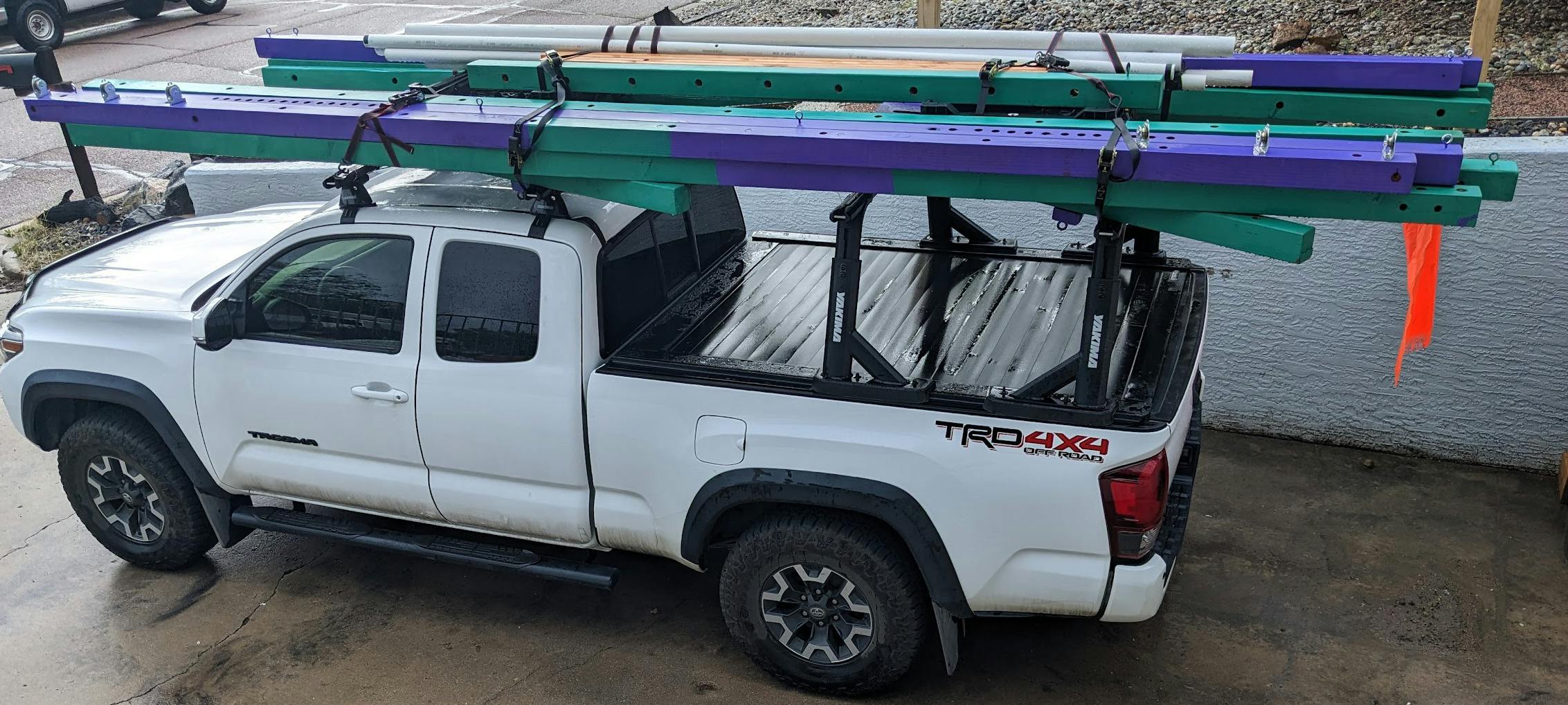 16-foot beams on a toyota tacoma, ratchet strapped to the kind of roof racks you might use to transport a kayak