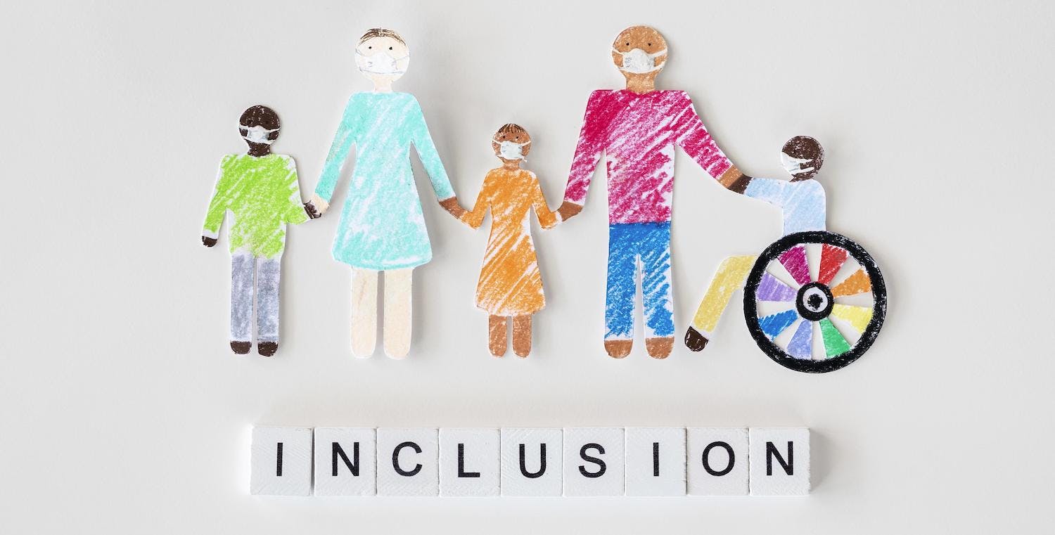 Family with a disabled person cut out paper, representing the concept of inclusion.