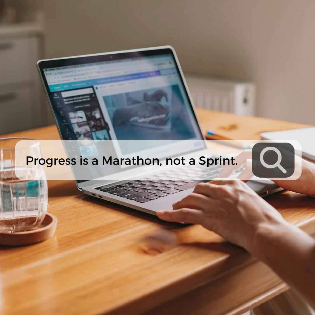 A hand typing on a laptop with a pop up search bar searching for "Progress is a Marathon, not a Sprint."