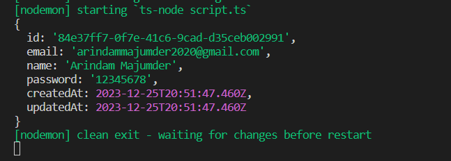 A terminal screen displaying a JSON object with user information, including an ID, email, name, password, and timestamps for creation and update. The terminal also shows a message indicating a clean exit and waiting for changes before restart.