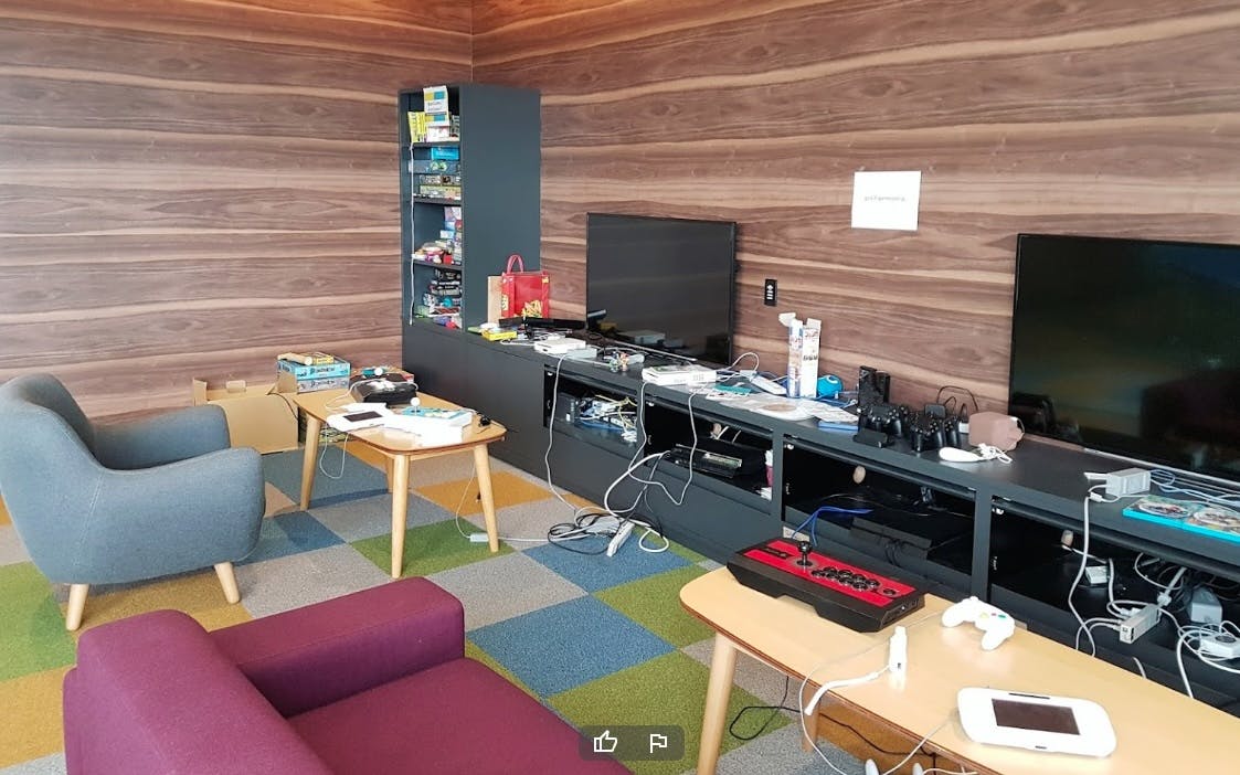 a game room in a Google office in Japan, with many board games and gaming consoles, and relaxing chairs