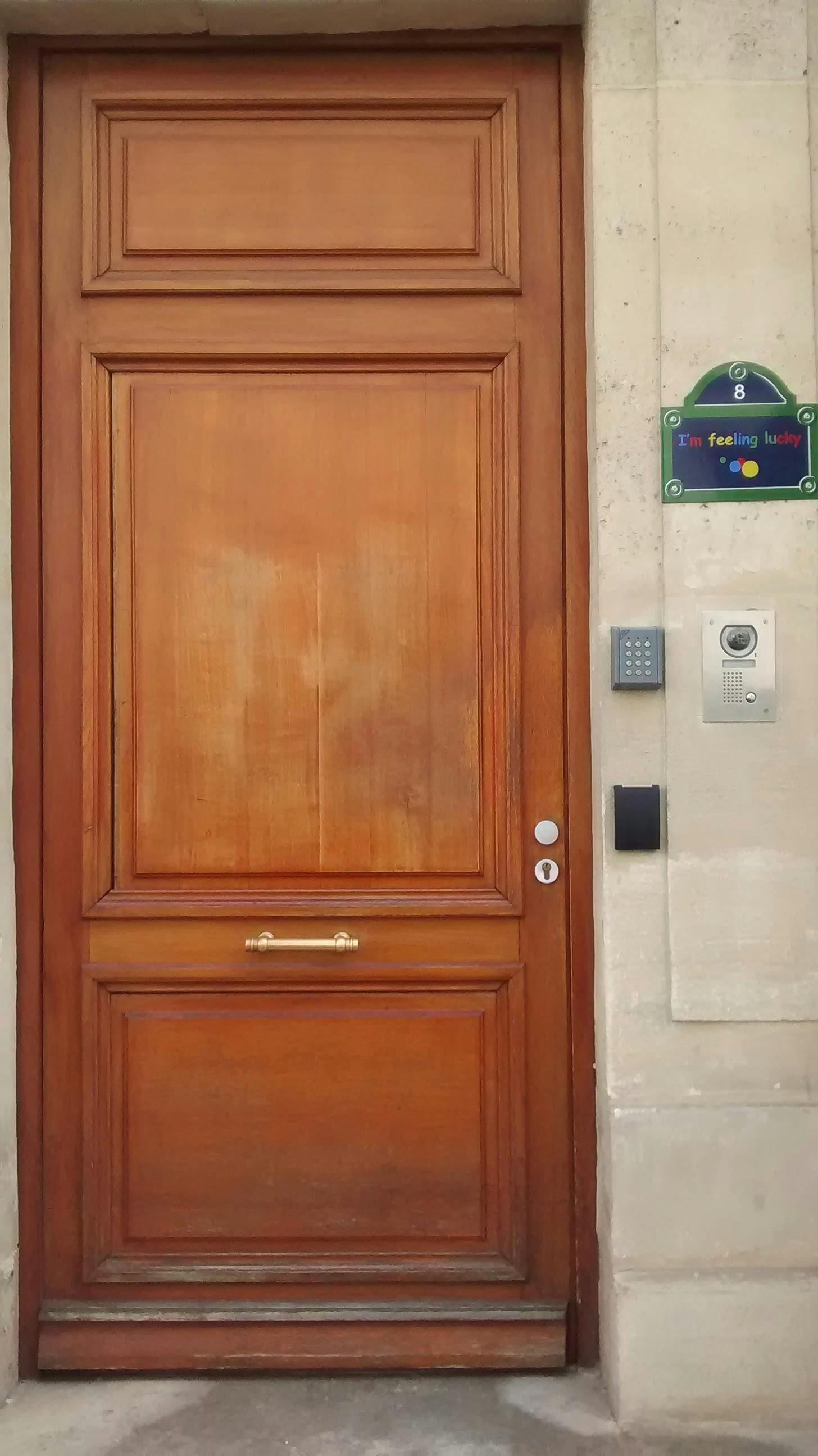 a wooden door that is the entrance to a Google office in Paris