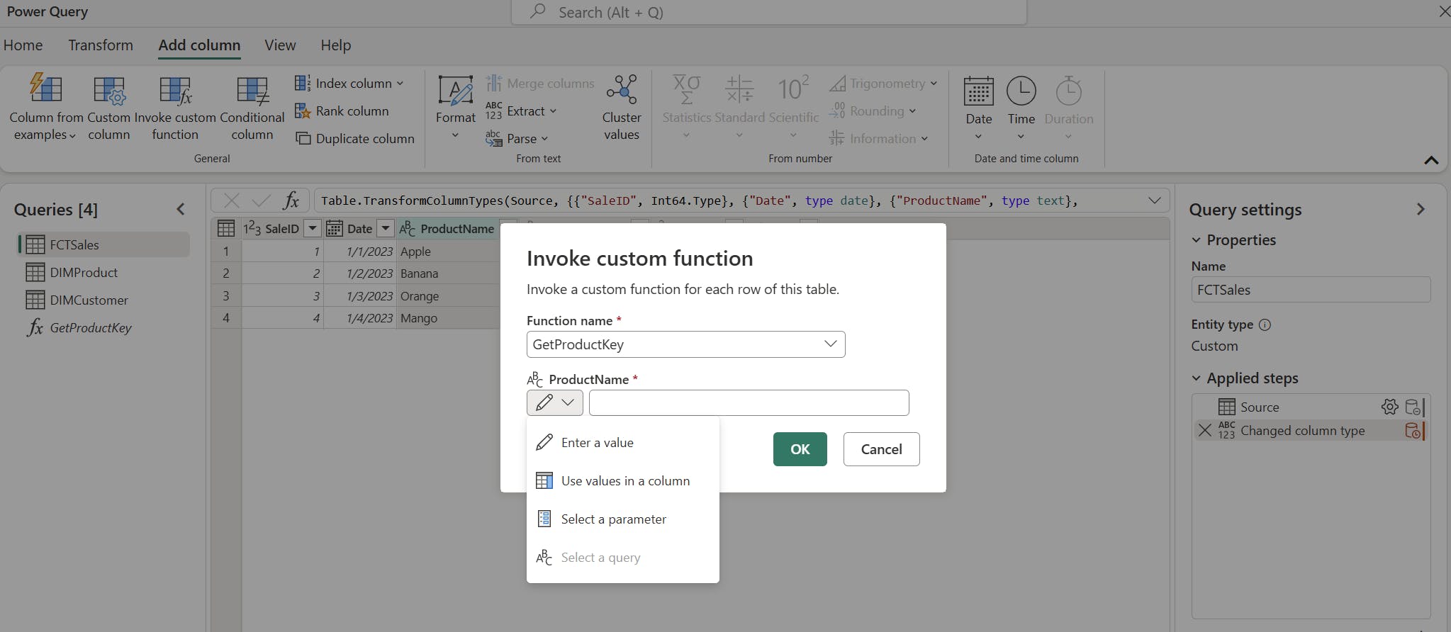 A screenshot of Power Query in Microsoft Fabric. The "Invoke custom function" dialog box is open, with fields for "Function name" and "ProductName." The drop-down menu under "ProductName" displays options such as "Enter a value," "Use values in a column," "Select a parameter," and "Select a query." The background shows a data table with columns for "SaleID," "Date," and "ProductName," containing items like Apple, Banana, Orange, and Mango. The Queries pane lists FCTSales, DIMProduct, DIMCustomer, and GetProductKey. The Query settings pane shows the name "FCTSales" and applied steps including "Source" and "Changed column type."