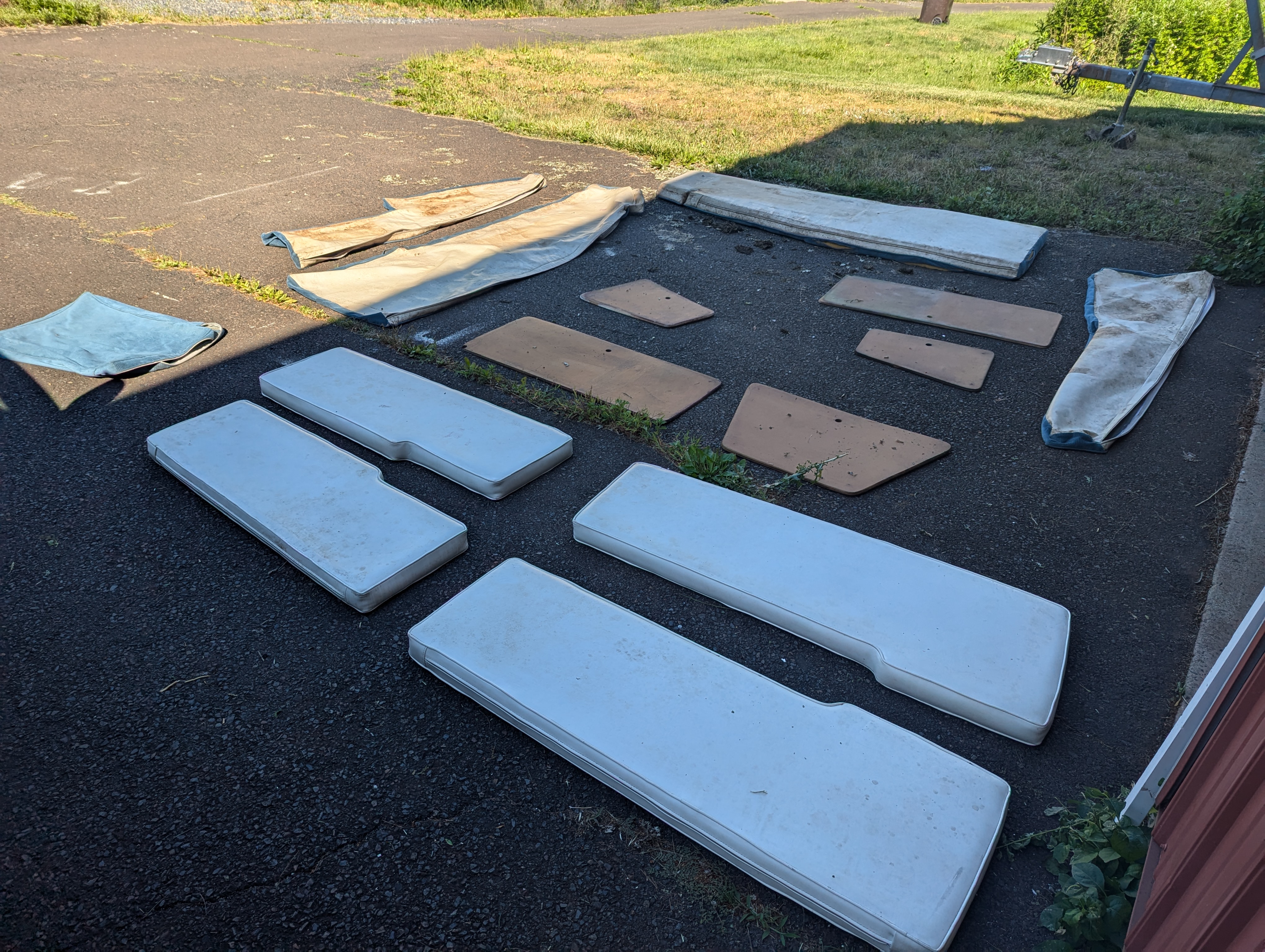 Various cushions and cushion covers spread out on the ground to air out