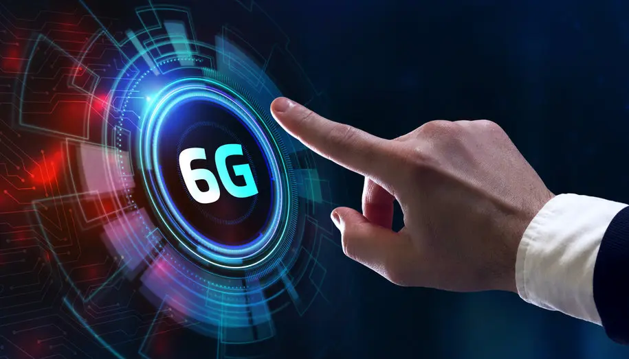 A hand pointing towards a futuristic digital interface displaying "6G".