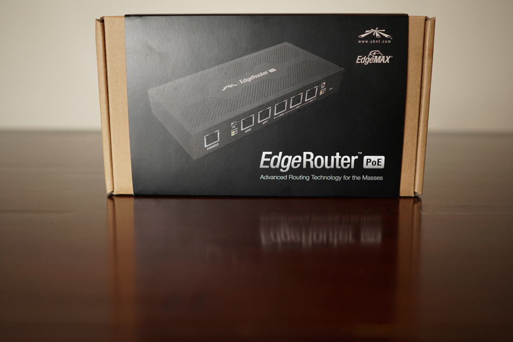 A box of Ubiquiti EdgeRouter PoE on a wooden surface.