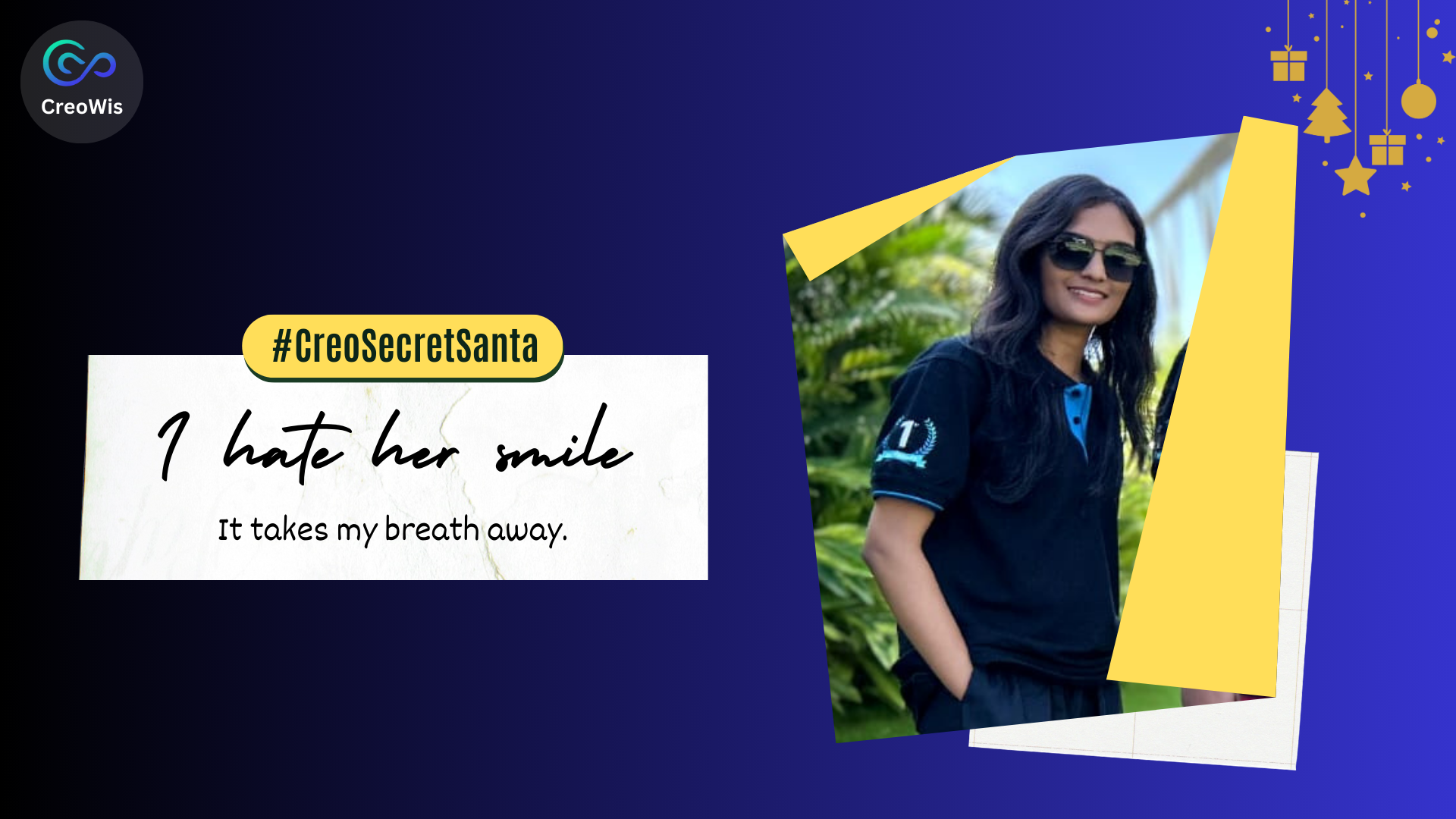 A woman wearing sunglasses and a black polo shirt stands outdoors, smiling. A message on the left reads "I hate her smile, it takes my breath away," with the hashtag #CreoSecretSanta. The image has a festive, blue background with holiday decorations.