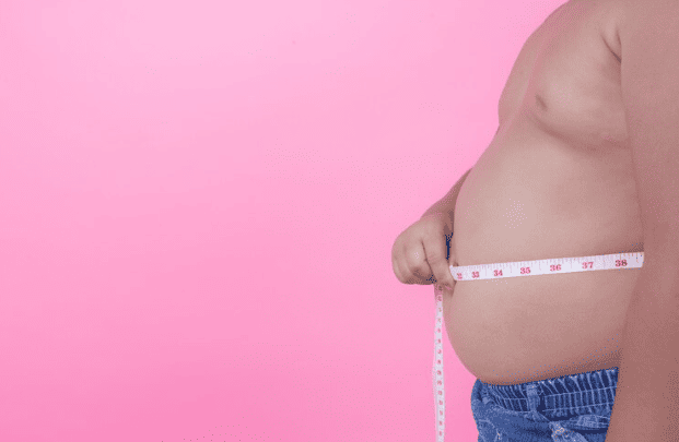 A man measuring his belly fat