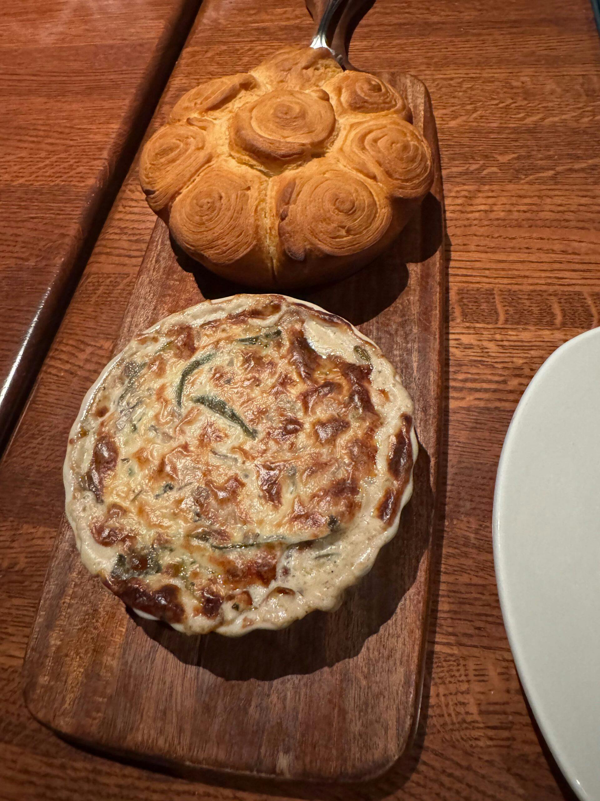 appetizer of rolls in a spiral crescent shape with a dip of mushrooms and poblano peppers in cheese