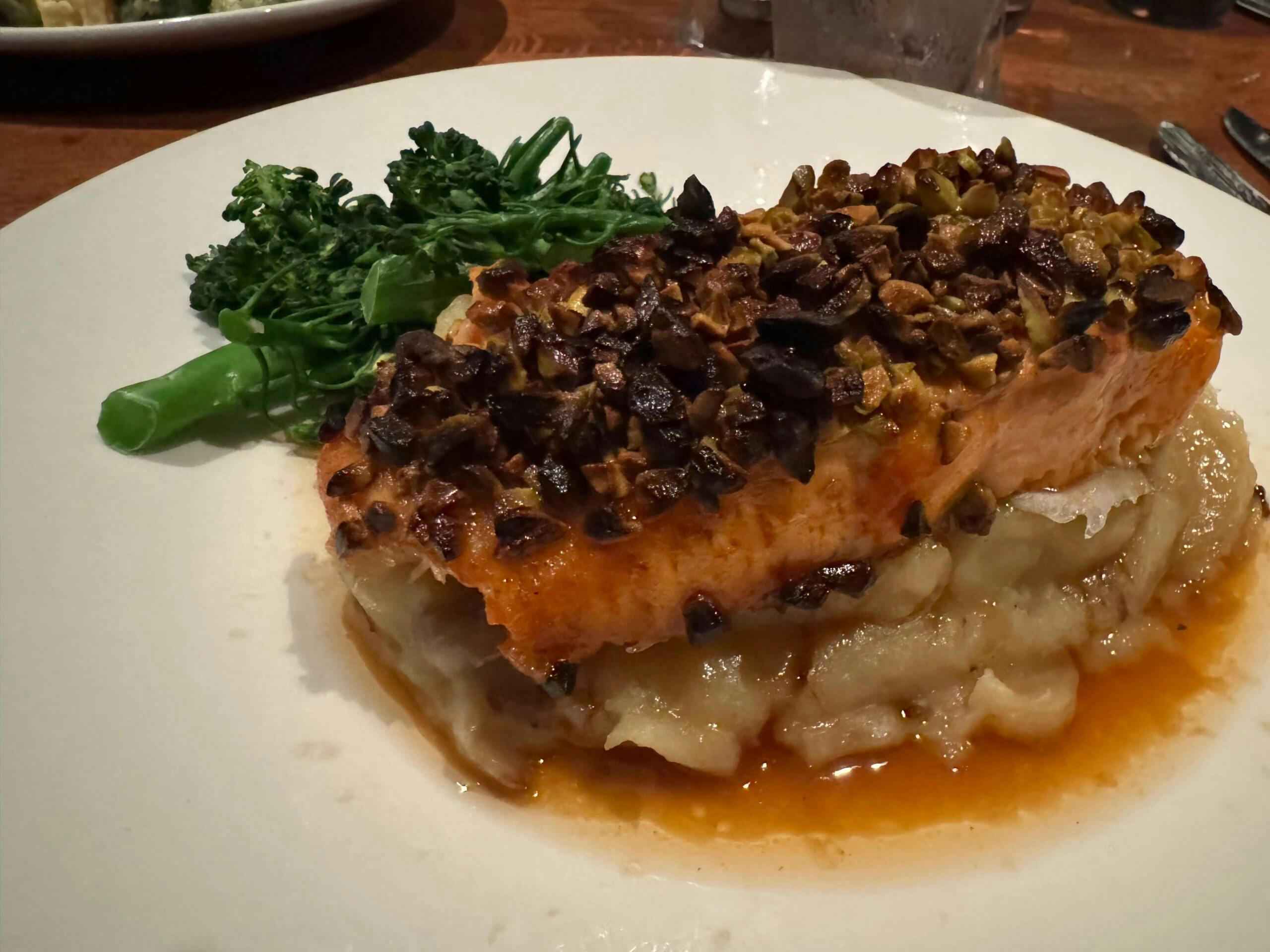 pistachio encrusted maple glazed salmon on a bed of mashed potatoes with broccoli