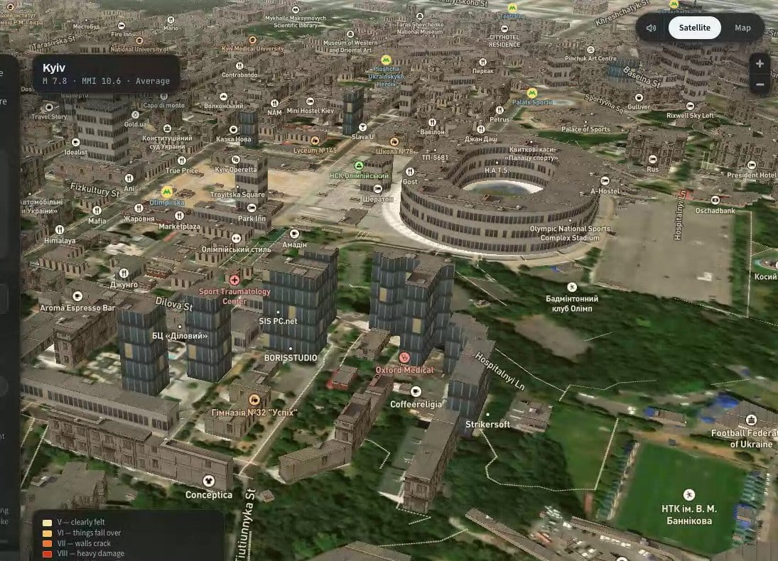 Pitched close-up of a Kyiv street. Several textured high-rise towers rebuilt as three.js models stand among the extruded buildings, ready for the shaking to start; the Olympic stadium model is in the background.